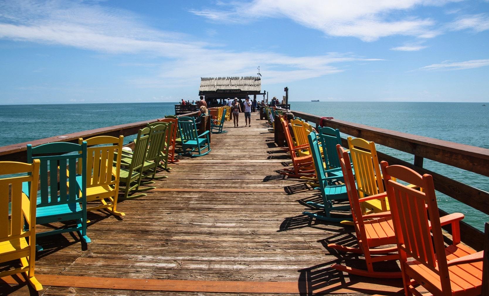 Colorful wooden chairs along the Cocoa Beach Pier